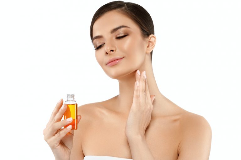 Woman with oil cosmetic beauty skin care concept. Young female model spa with oil skincare